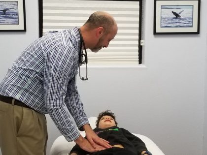 Dr. Cory Tichauer examining a patient